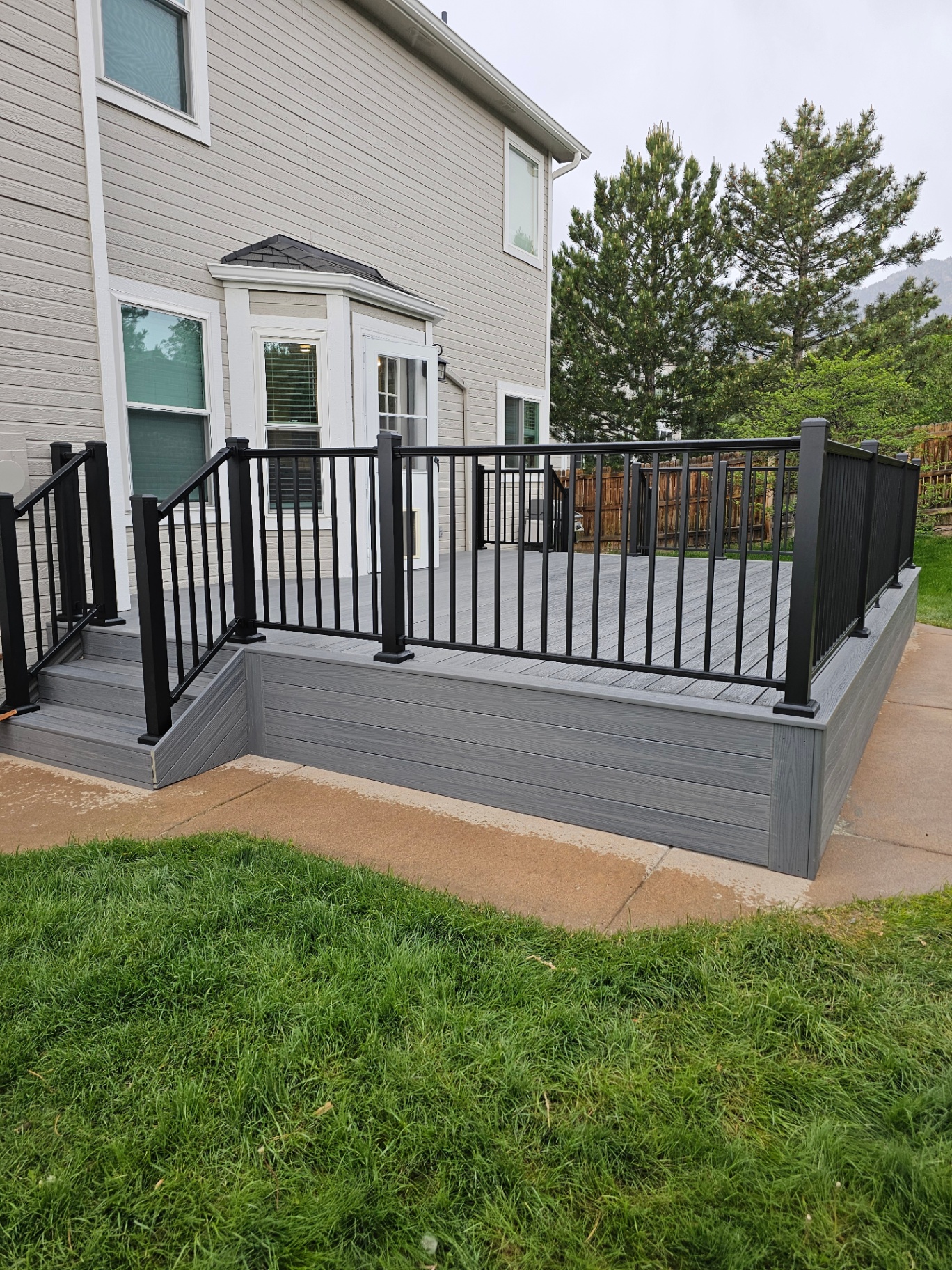 After — Bare Patio → Composite Deck with Railing